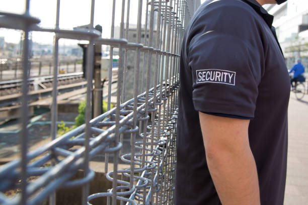 A closeup shot of a security guard in uniform patrolling at a station